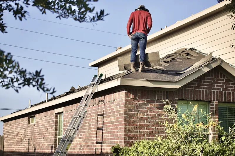 Professional roofer working on a residential roof in Bellwood
